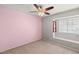 A simple bedroom with a ceiling fan and natural light from the window at 2802 Secret Canyon Rd, Las Vegas, NV 89074