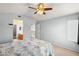 Comfortable bedroom with a ceiling fan, a large bed with floral pattern bedding, and a view to the loft at 2802 Secret Canyon Rd, Las Vegas, NV 89074
