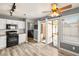 Open kitchen with white cabinets, stainless steel appliances, and access to the backyard at 2802 Secret Canyon Rd, Las Vegas, NV 89074