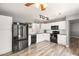 Bright kitchen with white cabinets, wood-look floors, and stainless steel appliances at 2802 Secret Canyon Rd, Las Vegas, NV 89074