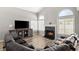 Comfortable living room featuring a stone fireplace and large windows at 2802 Secret Canyon Rd, Las Vegas, NV 89074