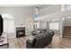 Spacious living room featuring a cozy fireplace, modern sofa, and hardwood floors at 2802 Secret Canyon Rd, Las Vegas, NV 89074