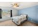 Comfortable bedroom with a ceiling fan, carpeted floors, and natural light at 2802 Secret Canyon Rd, Las Vegas, NV 89074