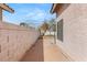 The side yard features a brick-paved pathway and a well-maintained stucco wall, creating a clean and inviting outdoor space at 2802 Secret Canyon Rd, Las Vegas, NV 89074