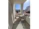 Staged balcony featuring a table and chairs for outdoor dining and relaxation at 3318 N Decatur Blvd # 1059, Las Vegas, NV 89130