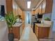 Galley kitchen featuring wooden cabinets, stainless steel appliances, and ample counter space at 3318 N Decatur Blvd # 1059, Las Vegas, NV 89130
