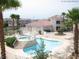 Community pool with a jacuzzi, ample seating, and well-manicured landscaping at 3318 N Decatur Blvd # 1059, Las Vegas, NV 89130