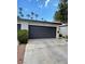 Two-car garage with a driveway and landscaped surroundings at 3436 Pino Cir, Las Vegas, NV 89121