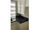 Features white cabinets, black countertops, and a kitchen window at 3436 Pino Cir, Las Vegas, NV 89121