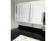 Presents white cabinets, black countertop, and mosaic tile backsplash at 3436 Pino Cir, Las Vegas, NV 89121