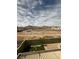Expansive backyard with a sparkling pool, artificial grass, and mountain views at 3917 White Castle St, Las Vegas, NV 89129
