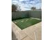 Low-maintenance backyard featuring artificial turf, rock accents, and lush landscaping at 3917 White Castle St, Las Vegas, NV 89129