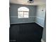 Cozy bedroom featuring dark carpet, decorative ceiling fan, chair rail, and a window overlooking the neighborhood at 3917 White Castle St, Las Vegas, NV 89129