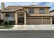 Two-story stucco home featuring a tile roof, arched windows, and a three-car garage at 3917 White Castle St, Las Vegas, NV 89129