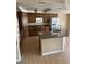 Traditional kitchen with wood cabinets, granite countertops, kitchen island, and stainless steel refrigerator at 3917 White Castle St, Las Vegas, NV 89129