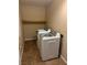 This laundry room features a washer, dryer, and floating shelf for optimal organization at 3917 White Castle St, Las Vegas, NV 89129
