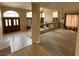Open-concept living room featuring tile and carpet flooring, and double door entry at 3917 White Castle St, Las Vegas, NV 89129