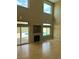 Spacious living room featuring hardwood floors, fireplace, and large windows overlooking the pool at 3917 White Castle St, Las Vegas, NV 89129