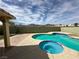 Beautiful pool and spa nestled in a private backyard with views of the surrounding mountains at 3917 White Castle St, Las Vegas, NV 89129