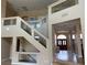 Open staircase design with glass railing details, with abundant natural light in a spacious foyer at 3917 White Castle St, Las Vegas, NV 89129