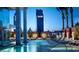 Modern outdoor pool and lounge area with palm trees and seating with Palms Casino Resort in background at 4381 W Flamingo Rd # 26320, Las Vegas, NV 89103