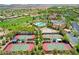 Aerial view of a community with a pool, golf course, and tennis courts at 4705 Bersaglio St, Las Vegas, NV 89135