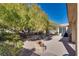 Lush backyard with mature trees and a covered patio at 4705 Bersaglio St, Las Vegas, NV 89135