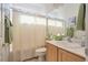 Well-lit bathroom featuring functional design with sink, toilet, and shower curtain at 4705 Bersaglio St, Las Vegas, NV 89135