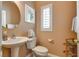 Well-lit half bathroom with a pedestal sink, modern fixtures, and a neutral color scheme at 4705 Bersaglio St, Las Vegas, NV 89135