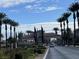 Community entrance with a gate and palm trees along the sides of the street at 4705 Bersaglio St, Las Vegas, NV 89135