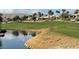 Golf course view with a small lake surrounded by the green of the golf course at 4705 Bersaglio St, Las Vegas, NV 89135