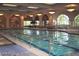 Spacious indoor pool with large windows and overhead lighting, perfect for year-round swimming at 4705 Bersaglio St, Las Vegas, NV 89135
