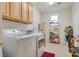 Spacious laundry room featuring modern washer and dryer, storage cabinets, and shelves at 4705 Bersaglio St, Las Vegas, NV 89135