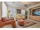 Cozy living room featuring comfortable seating, a ceiling fan, and natural light from shuttered windows at 4705 Bersaglio St, Las Vegas, NV 89135