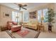 Bright living area with shuttered windows, neutral decor, and comfortable seating around a decorative rug at 4705 Bersaglio St, Las Vegas, NV 89135