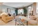 Bright living room featuring plush seating, a large window, and elegant decor at 4705 Bersaglio St, Las Vegas, NV 89135