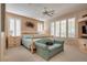Inviting primary bedroom featuring a comfortable bed, seating area, and shuttered windows for natural light at 4705 Bersaglio St, Las Vegas, NV 89135