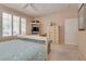 Spacious primary bedroom features a comfortable bed, shuttered windows, and built-in storage solutions at 4705 Bersaglio St, Las Vegas, NV 89135