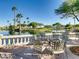Outdoor patio with table and chairs overlooking a lake with palm trees at 4705 Bersaglio St, Las Vegas, NV 89135