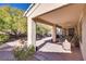 Covered patio with a ceiling fan, potted plants, and relaxing outdoor seating at 4705 Bersaglio St, Las Vegas, NV 89135