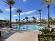A beautiful, large outdoor pool is surrounded by palm trees and lounge chairs for relaxation and sunbathing at 4705 Bersaglio St, Las Vegas, NV 89135