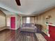 Comfortable living room features wood floors, a red accent door and neutral tones at 4756 Lake Pl, Las Vegas, NV 89147