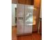 Kitchen with white refrigerator complemented by wood cabinetry and granite counters at 5049 Alfingo St, Las Vegas, NV 89135