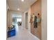 Modern entryway with a wood slat accent wall, tile flooring, blue bench and view into the living space at 506 Copper Falcon Ave, Henderson, NV 89011