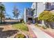 Inviting two-story townhome featuring a landscaped front yard and tiled walkway leading to the entrance at 5221 Crooked River Cir, Las Vegas, NV 89149