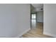 Hallway with hardwood flooring and access to rooms, featuring a view of the backyard at 5800 Balzar Ave, Las Vegas, NV 89108