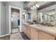 Main bathroom features a double sink vanity, tile floors, and a glass enclosed shower at 5945 Sunlight Garden Way, Las Vegas, NV 89118