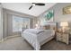 Cozy bedroom with a ceiling fan and a large window at 5945 Sunlight Garden Way, Las Vegas, NV 89118
