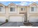 Charming townhome featuring a red tile roof, multiple windows and a two-car garage at 5945 Sunlight Garden Way, Las Vegas, NV 89118