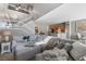 Spacious living room with comfortable seating, stairs, and open access to the dining room and kitchen at 5945 Sunlight Garden Way, Las Vegas, NV 89118